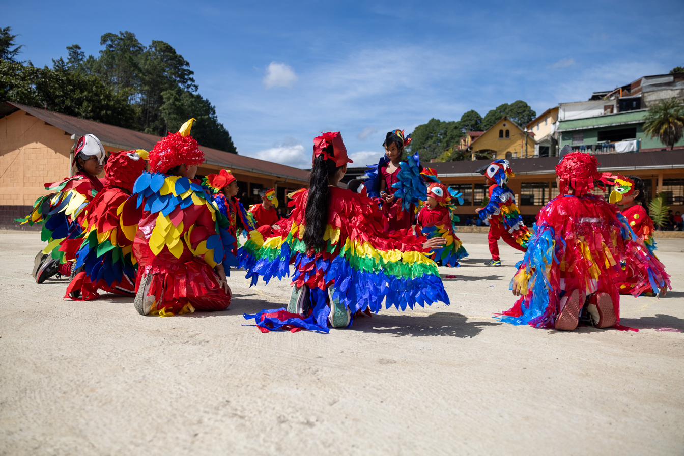 A student giving a thumbs up while holding maracas