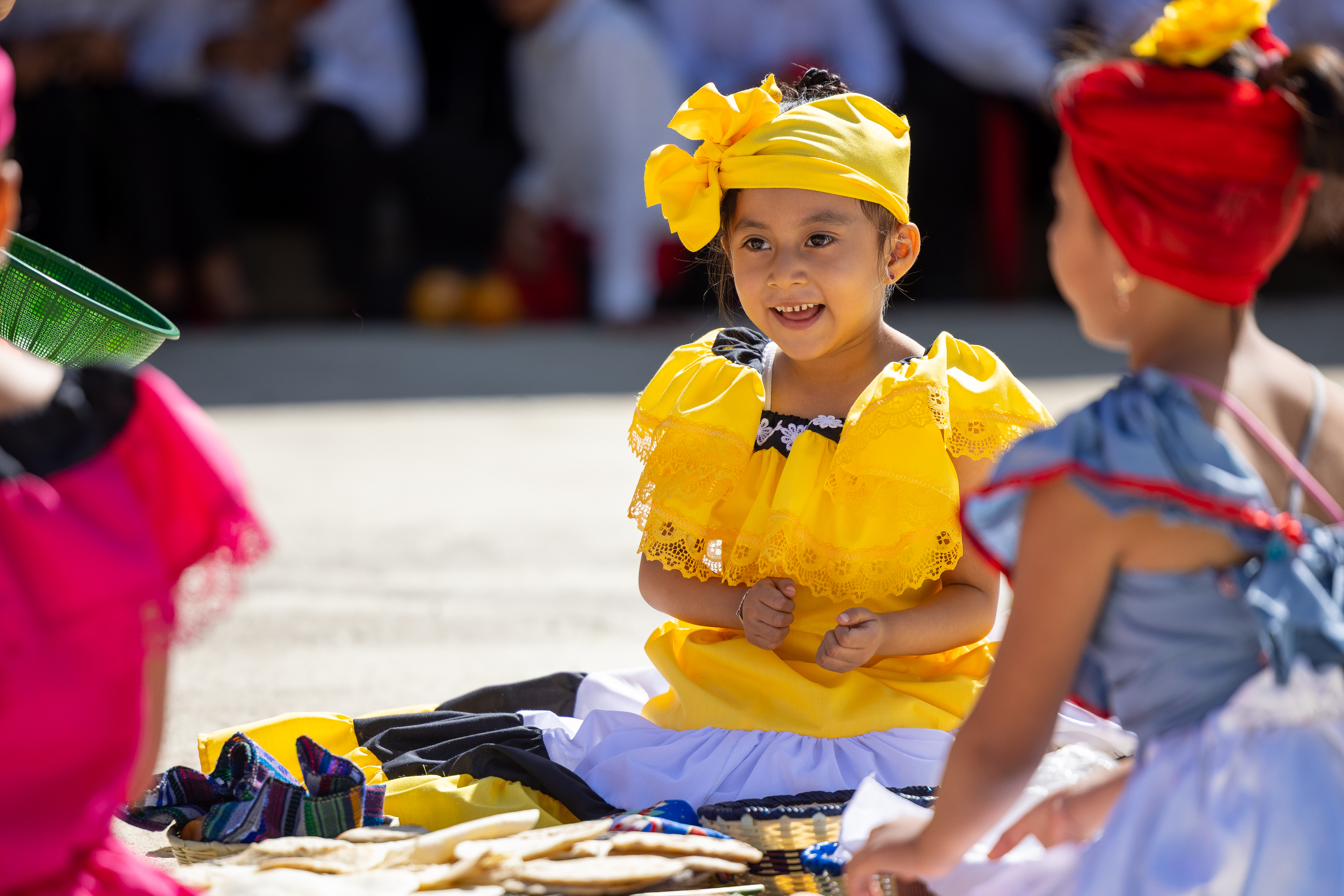 A child in a colorful traditional dance costume