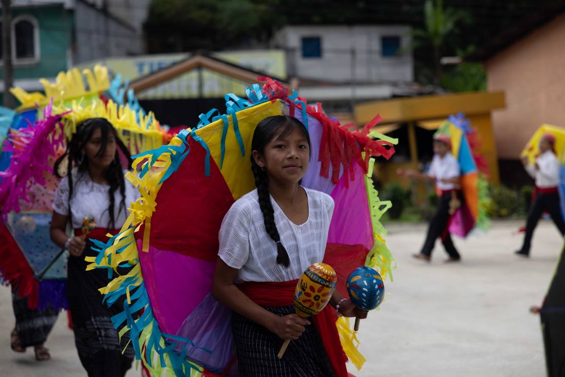 Students in colorful traditional costumes during a school celebration